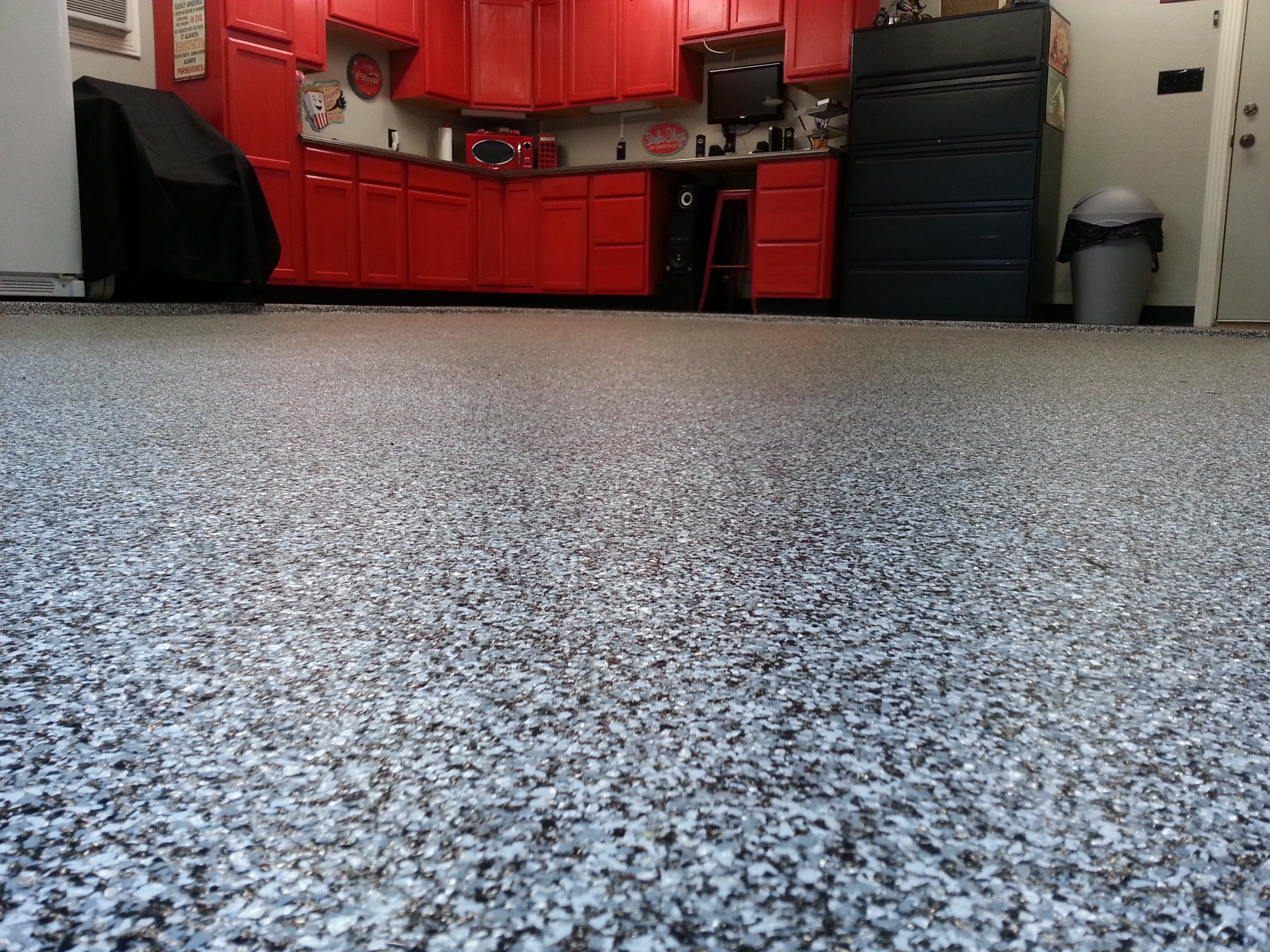 Blue and white flake floor in a garage kitchen